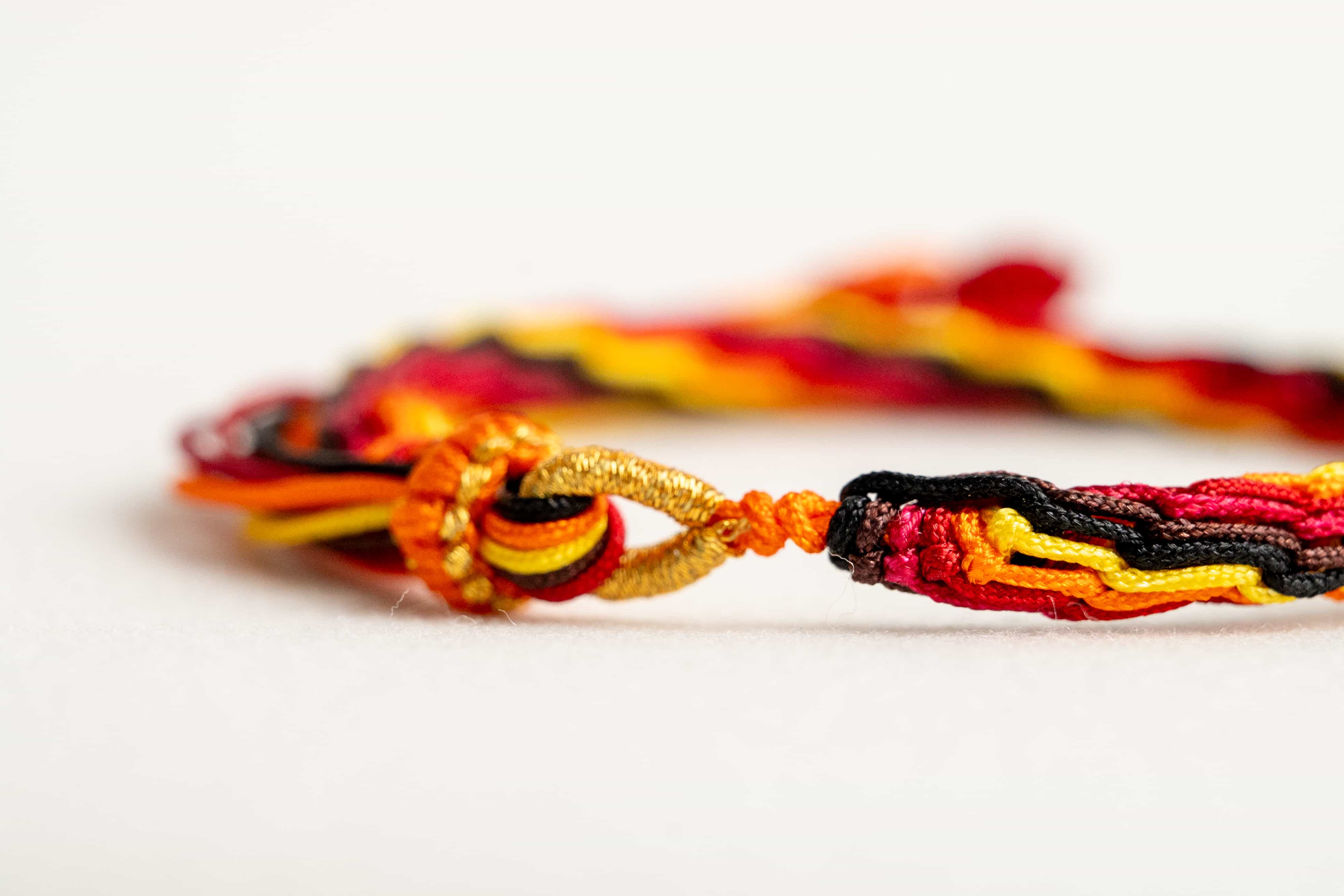 "WINTER SOLSTICE": Yellow and Red Handmade Braided Bracelet for Resilience