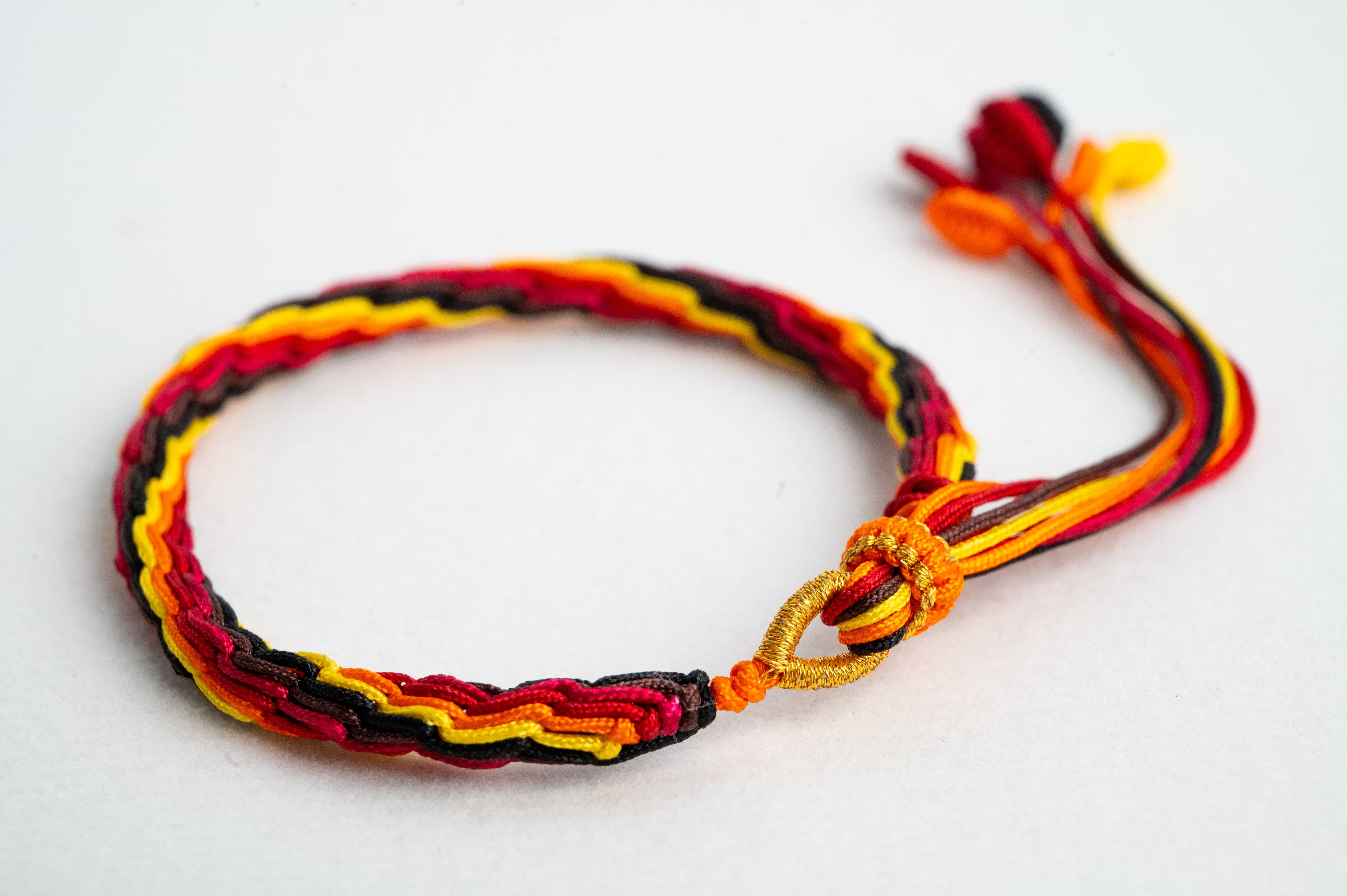 "WINTER SOLSTICE": Yellow and Red Handmade Braided Bracelet for Resilience