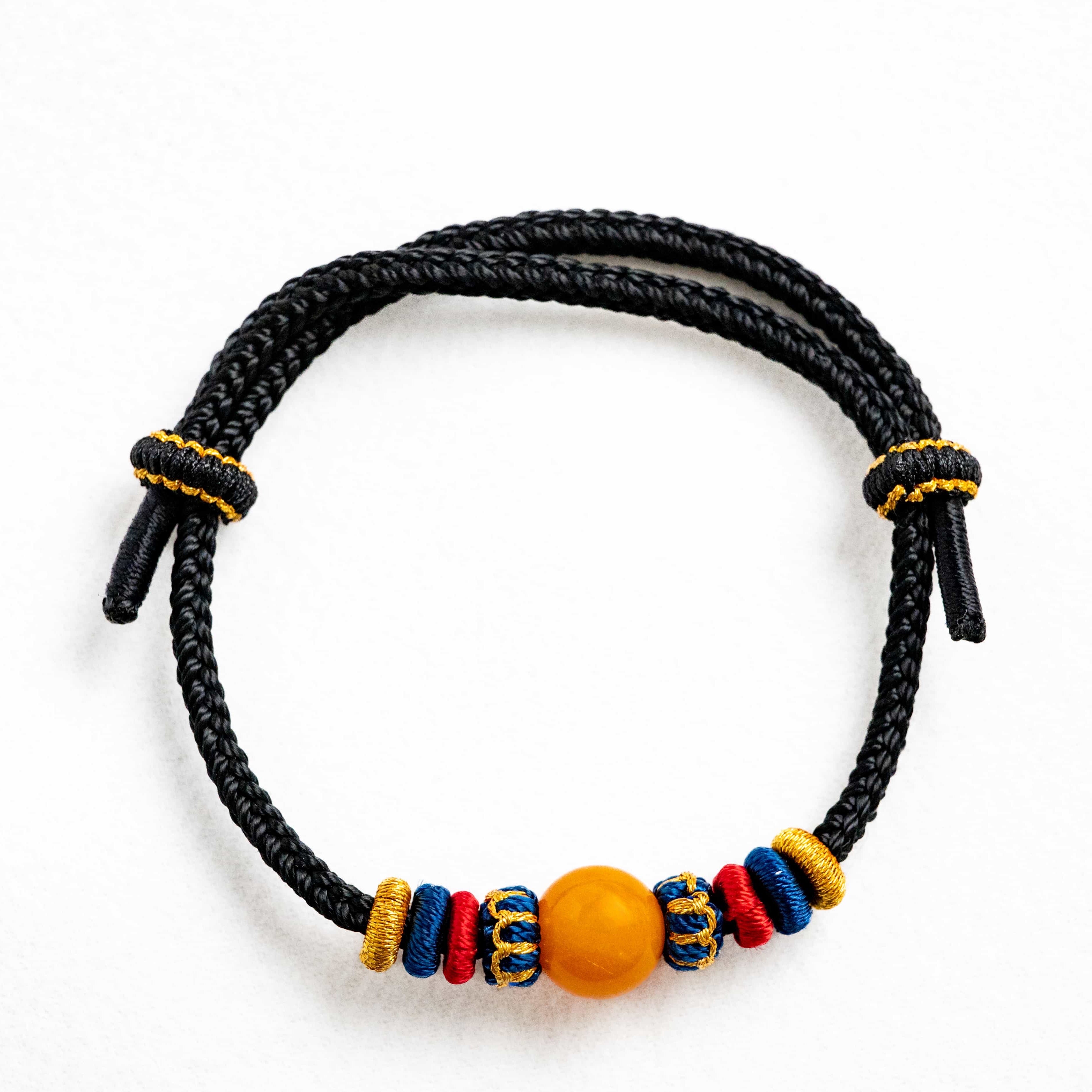 OMNI ENERGY: Honey Yellow Amber Braided Bracelet with Lucky Knots