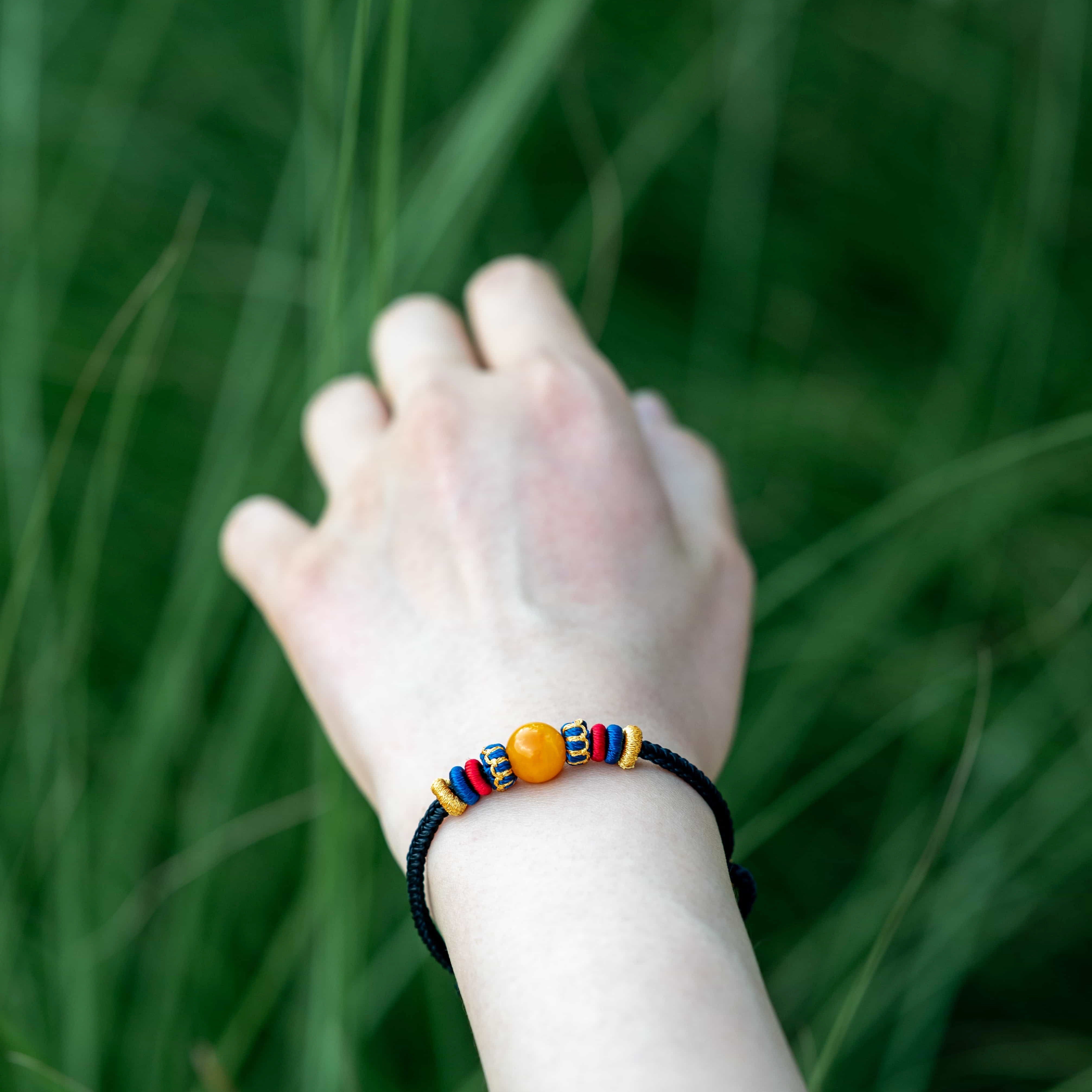 OMNI ENERGY: Honey Yellow Amber Braided Bracelet with Lucky Knots